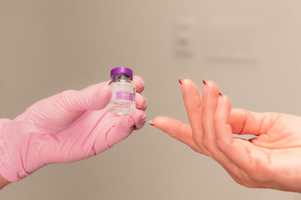Dr. West holds a vial of Botox during a patient's consultation for masseter Botox in Ann Arbor.