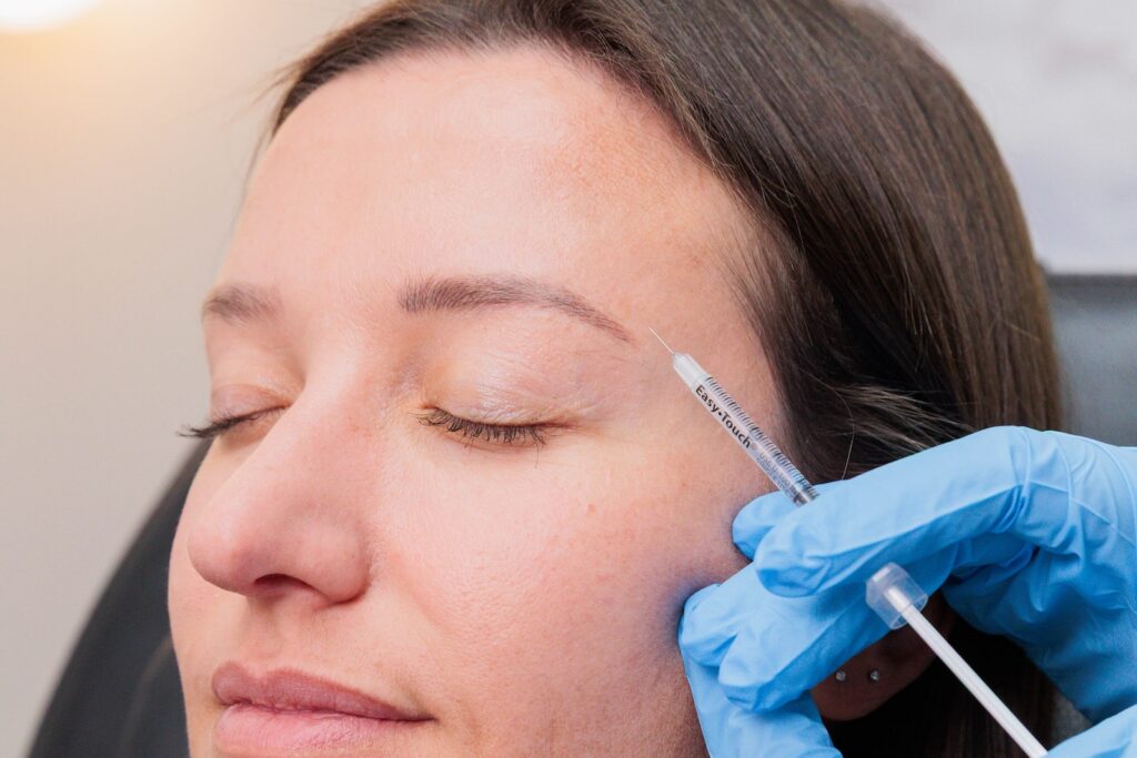 Dr. West prepares to place a patient's injections in her temporalis muscle, a placement often used in conjunction with masseter Botox in Ann Arbor.